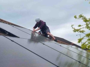 Man working on roof with full safety gear