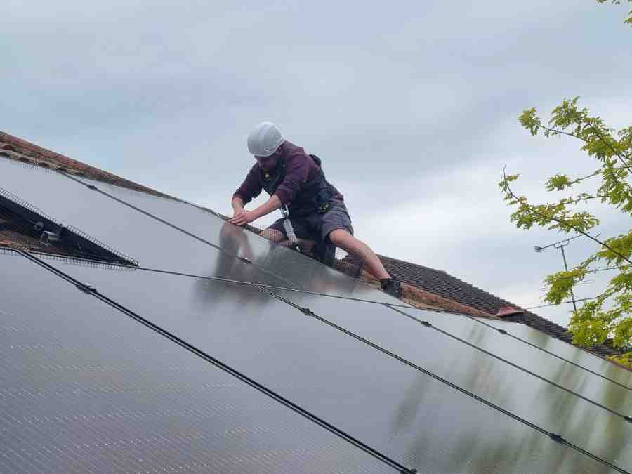 Man working on roof with full safety gear
